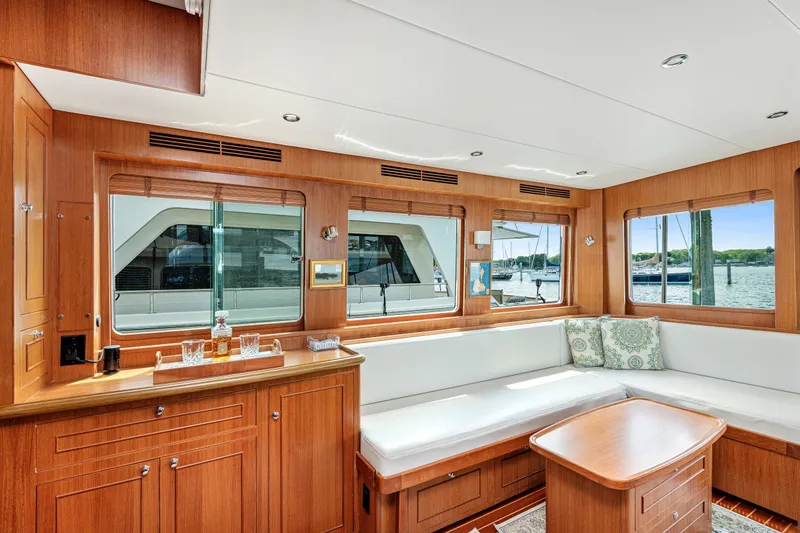 Slide: The Image of Luxurious interior of 2017 North Pacific 49 Pilothouse yacht with elegant wood finish and waterfront view. - 9