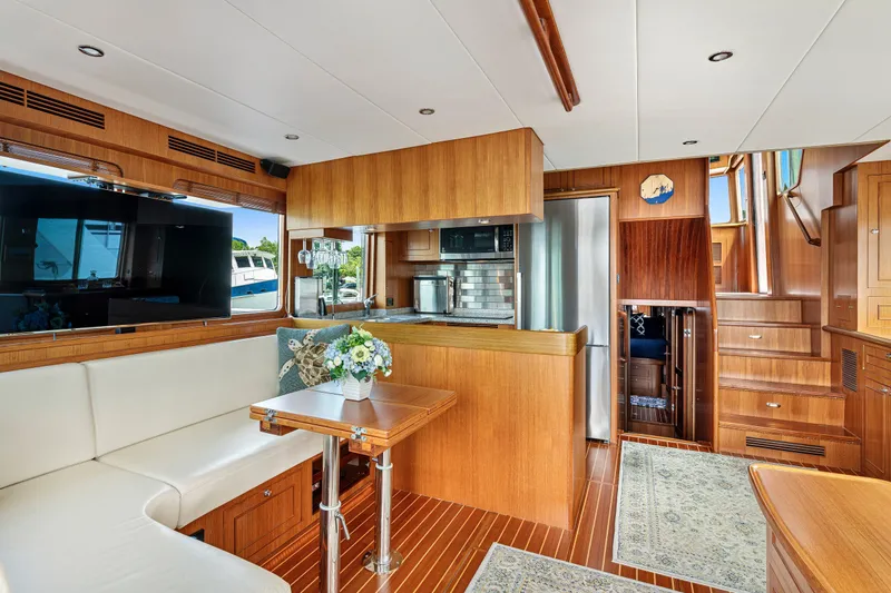 Slide: The Image of Luxurious interior of 2017 North Pacific 49 Pilothouse yacht with modern kitchen and seating area. - 13