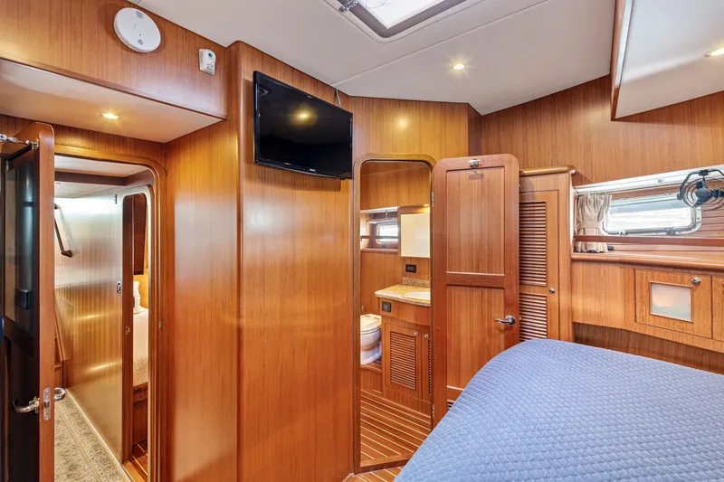 Slide: The Image of Luxurious interior of 2017 North Pacific 49 Pilothouse yacht with wood paneling and modern amenities. - 26