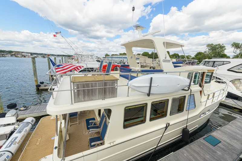 Slide: The Image of 2017 North Pacific 49 Pilothouse yacht docked at marina under cloudy sky. - 46