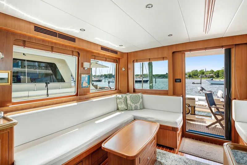 Slide: The Image of Luxurious interior of 2017 North Pacific 49 Pilothouse yacht with waterfront view. - 8