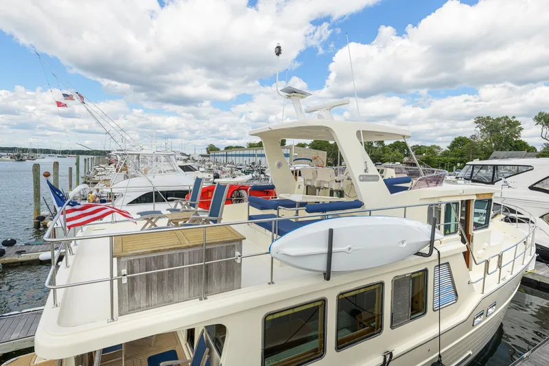Slide: The Image of 2017 North Pacific 49 Pilothouse yacht docked at marina under cloudy sky. - 47