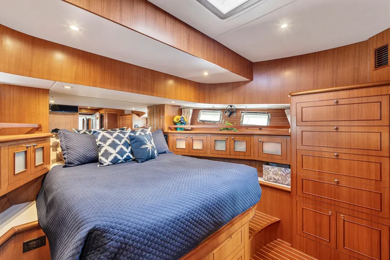 Slide: The Image of Luxurious 2017 North Pacific 49 Pilothouse cabin with elegant wood finish and cozy bedding. - 24