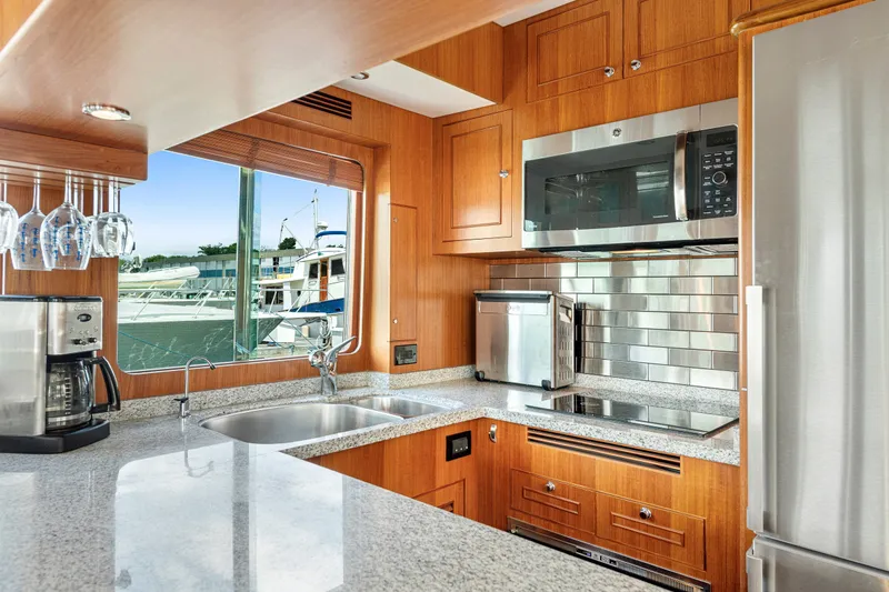 Slide: The Image of Luxurious kitchen interior of 2017 North Pacific 49 Pilothouse yacht with modern appliances. - 11
