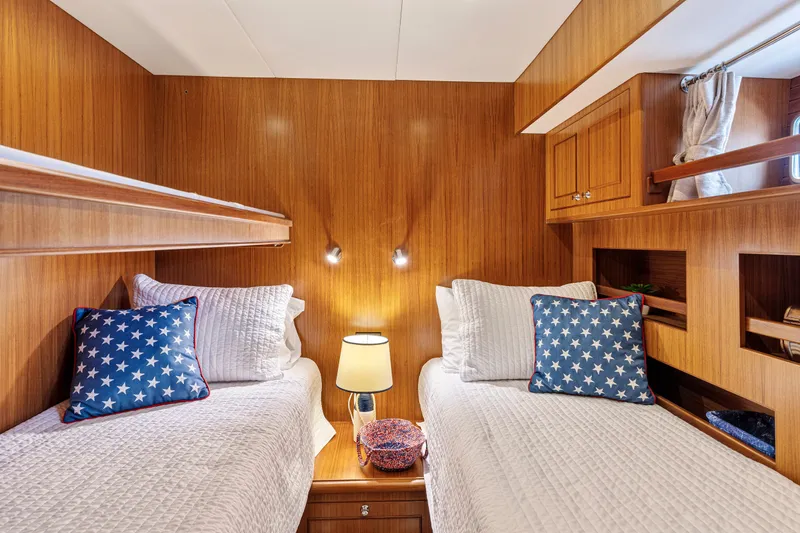 Slide: The Image of Cozy twin cabin in 2017 North Pacific 49 Pilothouse yacht with star-patterned pillows. - 18