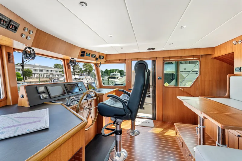Slide: The Image of Pilothouse interior of 2017 North Pacific 49, featuring navigation equipment and wooden finishes. - 33
