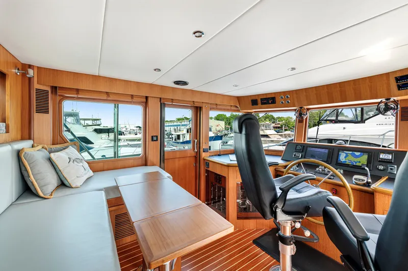 Slide: The Image of Luxurious 2017 North Pacific 49 Pilothouse interior with helm, seating, and navigation equipment. - 30