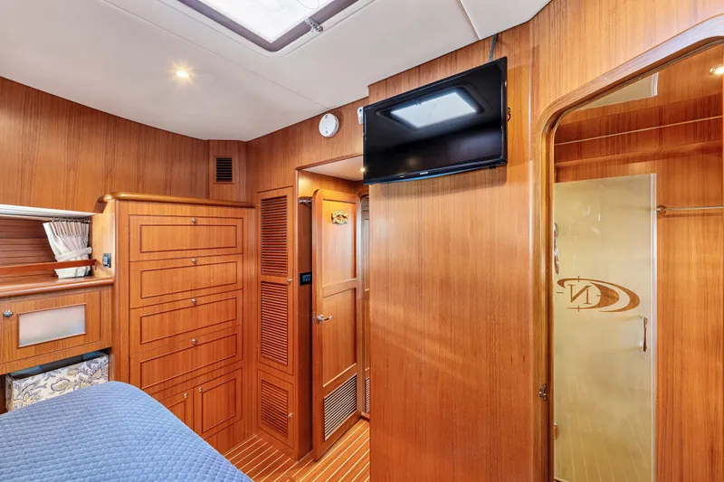 Slide: The Image of Luxurious 2017 North Pacific 49 Pilothouse cabin interior with wood paneling and modern amenities. - 25