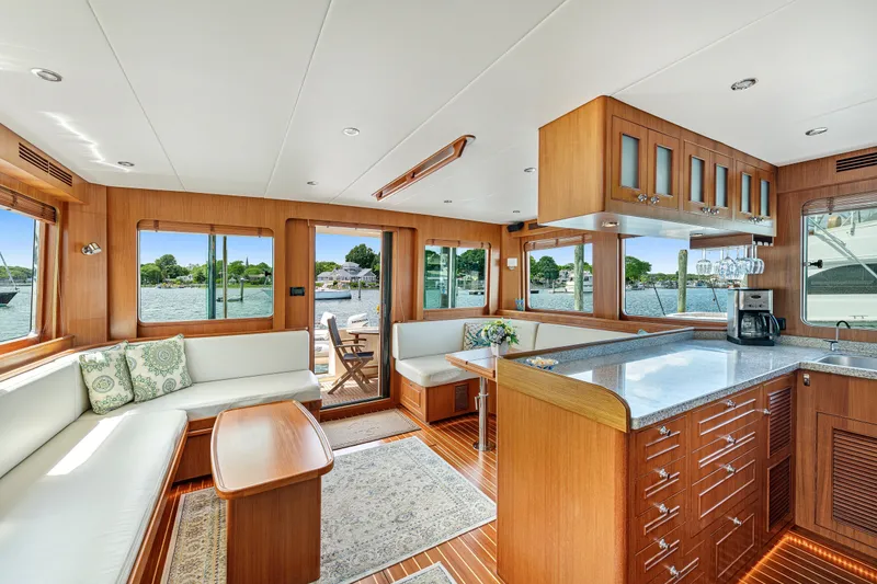 Slide: The Image of Luxurious interior of 2017 North Pacific 49 Pilothouse yacht with elegant wood finishes and waterfront views. - 7