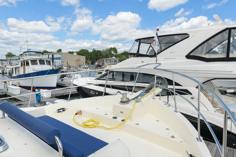 Slide: The Image of 2017 North Pacific 49 Pilothouse yacht docked at marina with other boats. - 75