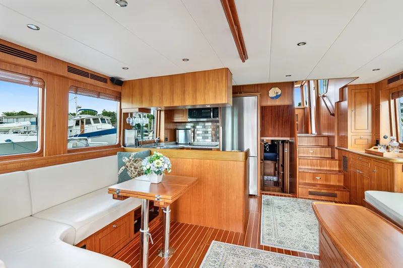 Slide: The Image of Luxurious interior of 2017 North Pacific 49 Pilothouse yacht with elegant wood finishes and modern amenities. - 3