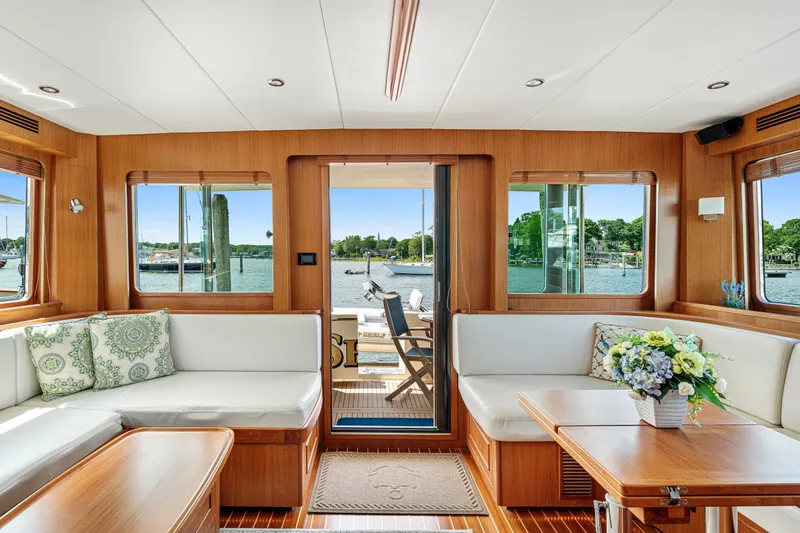 Slide: The Image of Luxurious interior of 2017 North Pacific 49 Pilothouse yacht with elegant seating and scenic views. - 4