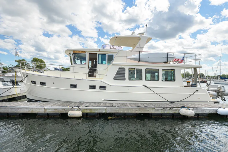 Slide: The Image of 2017 North Pacific 49 Pilothouse yacht docked at marina under cloudy sky. - 42