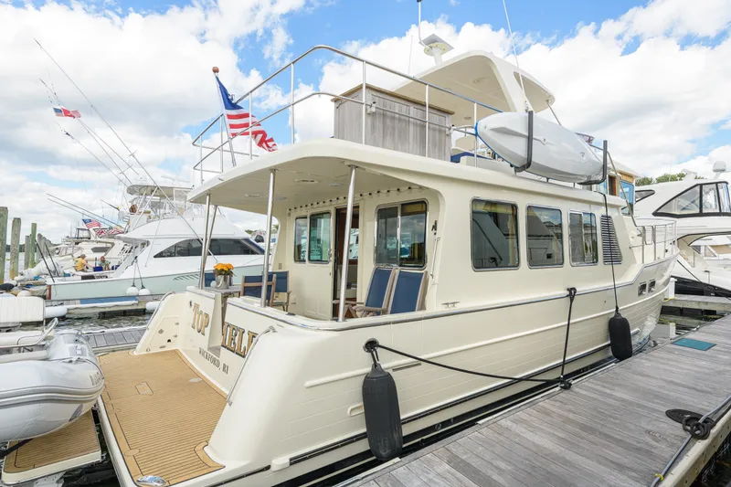 Slide: The Image of 2017 North Pacific 49 Pilothouse yacht docked at marina with clear skies. - 45