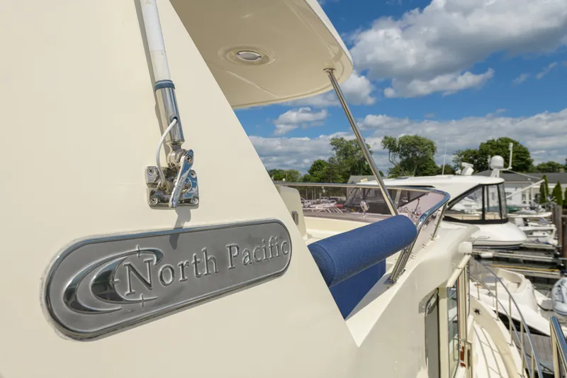 Slide: The Image of 2017 North Pacific 49 Pilothouse yacht docked under a blue sky. - 67
