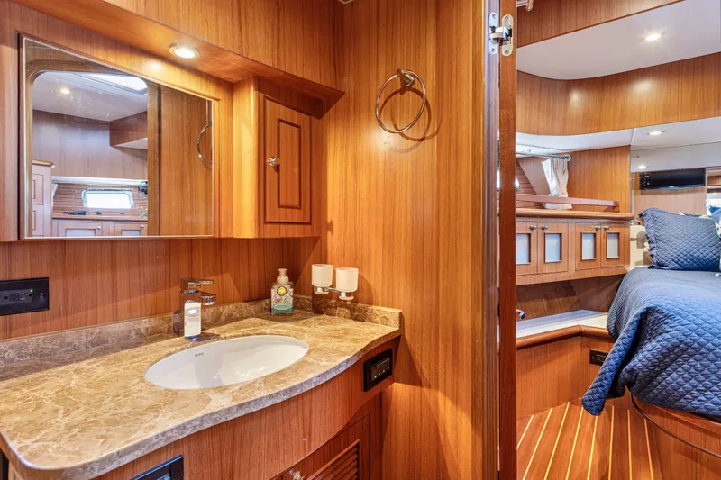 Slide: The Image of Luxurious 2017 North Pacific 49 Pilothouse interior with wood finish and cozy bedroom. - 29