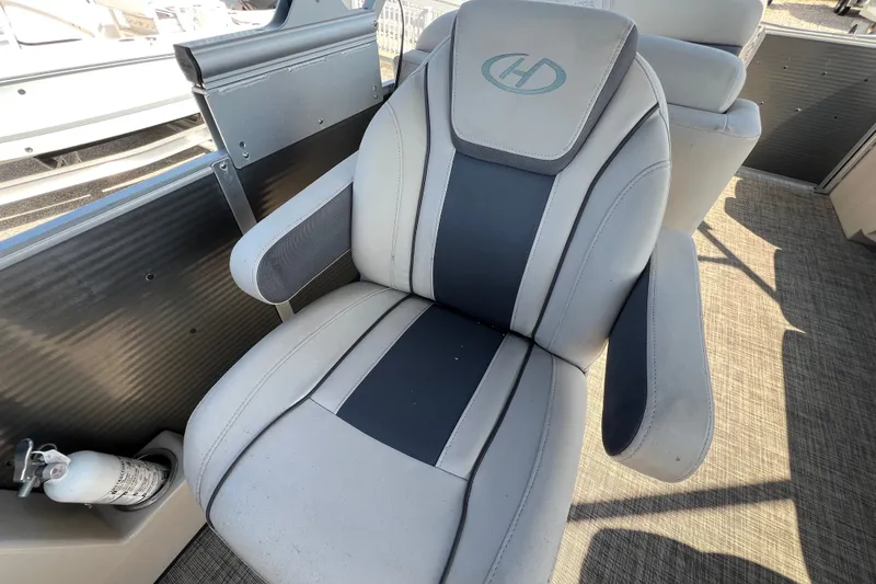 Slide: The Image of Captain's chair on 2023 Harris Cruiser 230 boat, featuring sleek design and comfortable seating. - 10