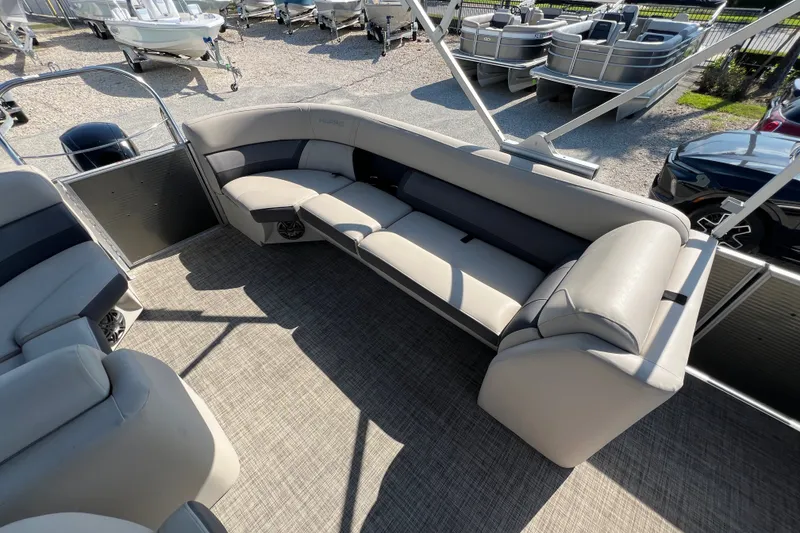 Slide: The Image of 2023 Harris Cruiser 230 pontoon boat interior with plush seating and spacious layout. - 11