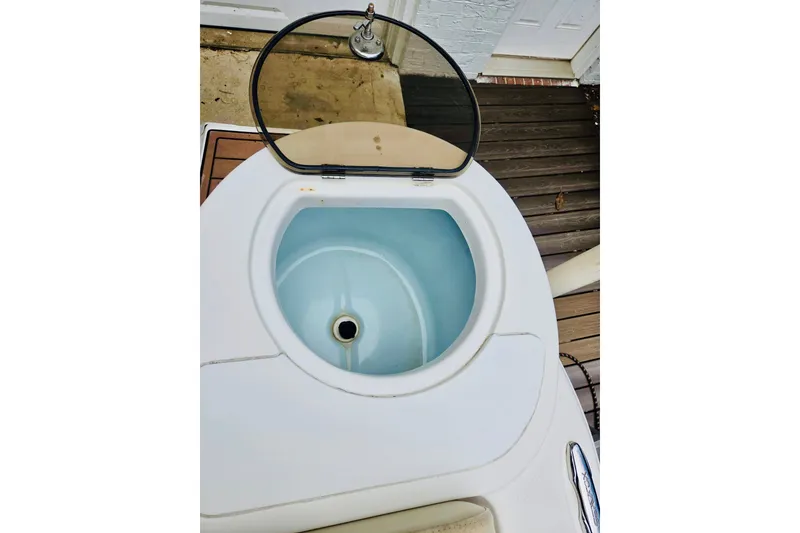 Slide: The Image of Livewell on 2017 Sea Fox 249 Avenger boat, open lid, white and blue interior. - 6