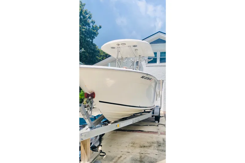 The Image of 2017 Sea Fox 249 Avenger boat on trailer, parked near a house. - 0