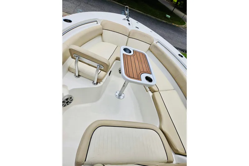 Slide: The Image of 2017 Sea Fox 249 Avenger boat interior with cushioned seating and a wooden table. - 7