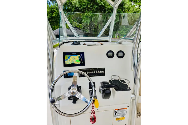 Slide: The Image of 2017 Sea Fox 249 Avenger boat dashboard with steering wheel and navigation display. - 1