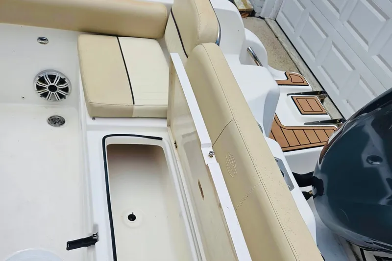 Slide: The Image of 2017 Sea Fox 249 Avenger boat interior with beige seating and storage compartment. - 5