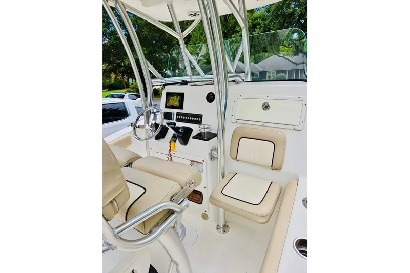 Slide: The Image of 2017 Sea Fox 249 Avenger boat interior with steering wheel and seating. - 2
