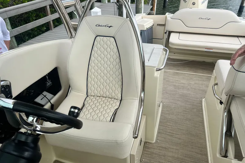 Slide: The Image of 2024 Chris-Craft Calypso 24 boat interior with luxurious seating and steering wheel. - 20