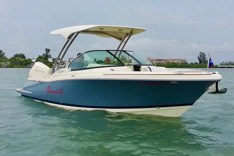 Slide: The Image of 2024 Chris-Craft Calypso 24 boat cruising on calm waters, showcasing sleek design and luxury. - 4