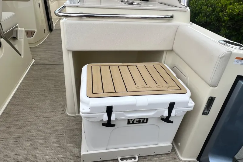 Slide: The Image of 2024 Chris-Craft Calypso 24 interior with Yeti cooler and custom wood top. - 17