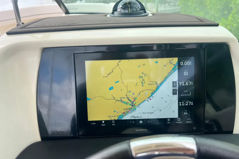 Slide: The Image of 2024 Chris-Craft Calypso 24 dashboard with Garmin navigation display. - 21