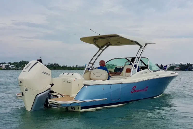 Slide: The Image of 2024 Chris-Craft Calypso 24 boat on water, featuring Mercury outboard engine. - 2