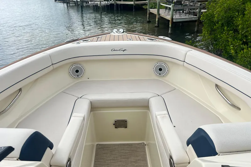 Slide: The Image of 2024 Chris-Craft Calypso 24 boat interior with white seating and waterfront view. - 24