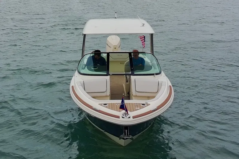 Slide: The Image of 2024 Chris-Craft Calypso 24 boat on water, front view with passengers. - 14