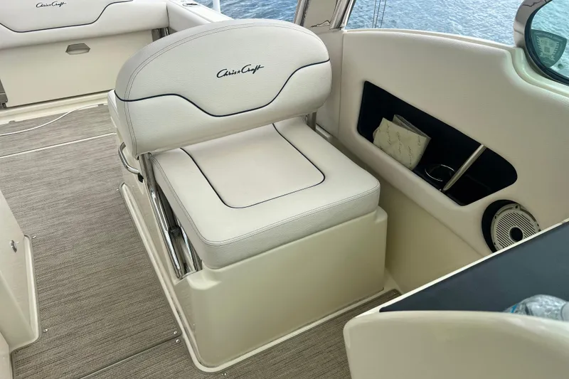 Slide: The Image of 2024 Chris-Craft Calypso 24 boat interior with white seating and storage compartments. - 19