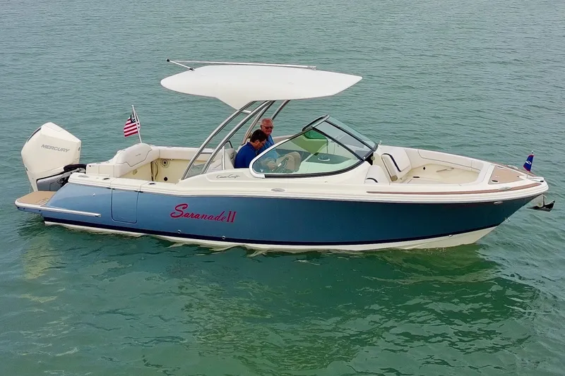 Slide: The Image of 2024 Chris-Craft Calypso 24 boat on water, featuring sleek design and modern amenities. - 1