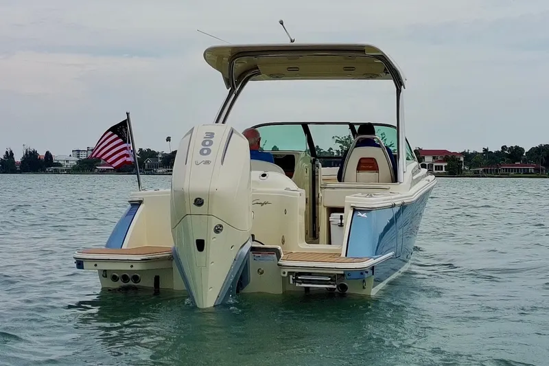 Slide: The Image of 2024 Chris-Craft Calypso 24 boat on water, rear view with American flag. - 9