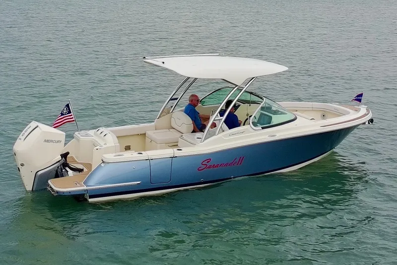Slide: The Image of 2024 Chris-Craft Calypso 24 boat on water, featuring sleek design and Mercury engine. - 3