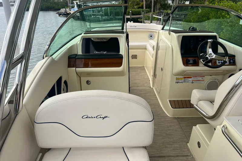 Slide: The Image of 2024 Chris-Craft Calypso 24 boat interior with elegant seating and modern dashboard. - 18
