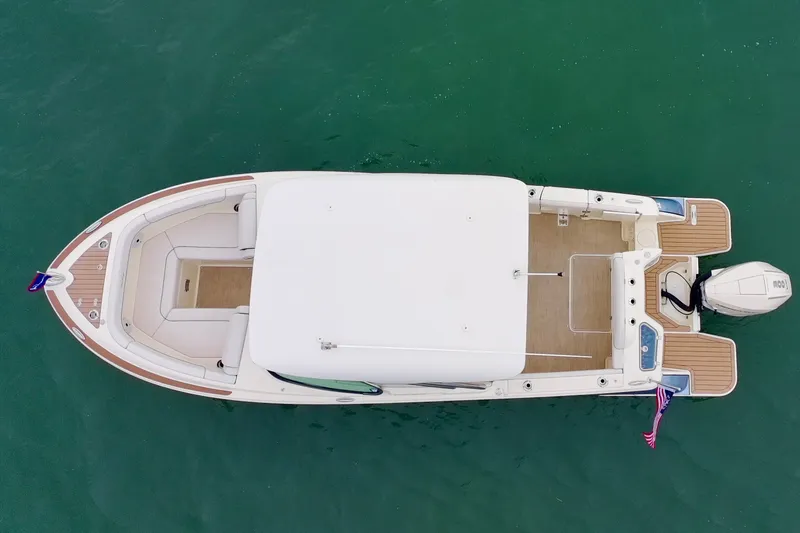 Slide: The Image of 2024 Chris-Craft Calypso 24 boat, aerial view, on calm green water. - 30