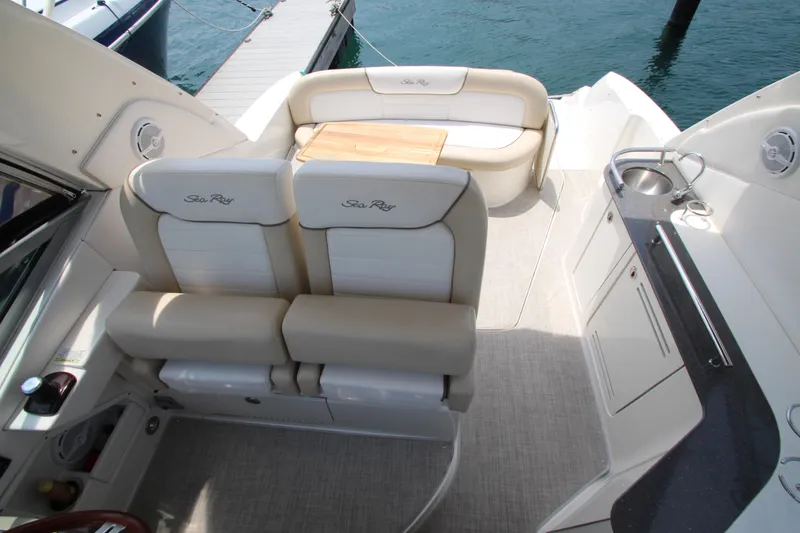 Slide: The Image of 2012 Sea Ray 330 Sundancer boat interior with seating and kitchenette. - 13