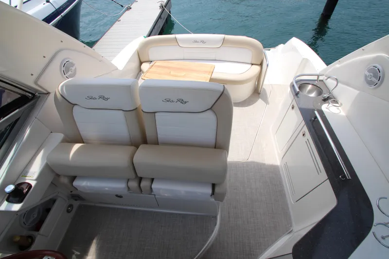 Slide: The Image of 2012 Sea Ray 330 Sundancer boat interior with seating and kitchenette. - 12