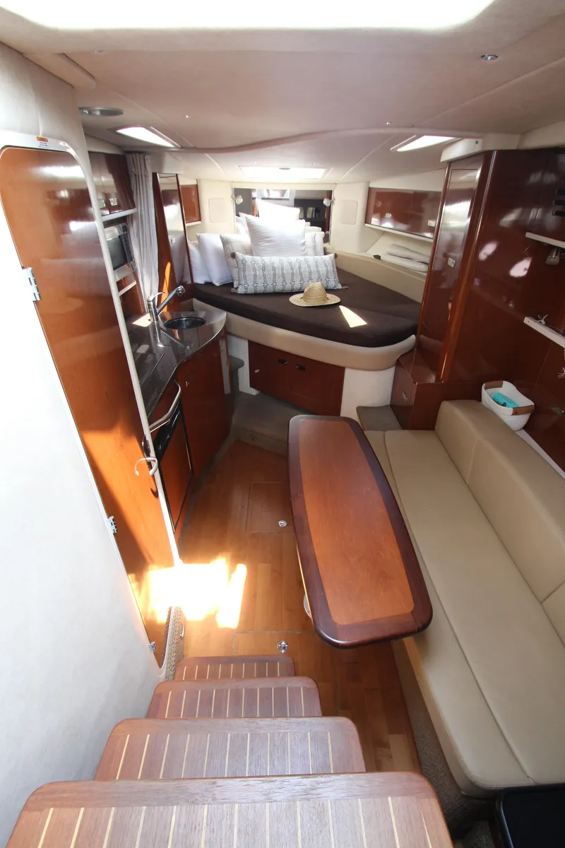 Slide: The Image of Interior of 2012 Sea Ray 330 Sundancer yacht with modern amenities and cozy seating. - 27