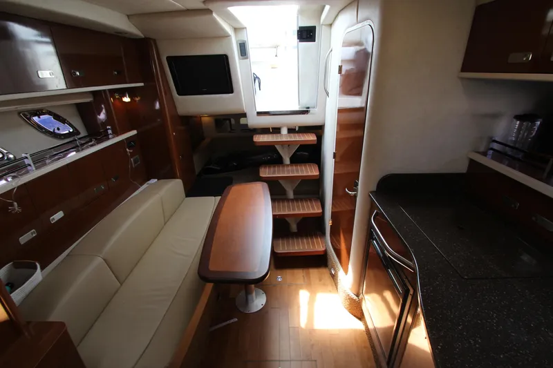 Slide: The Image of Interior of 2012 Sea Ray 330 Sundancer yacht with modern amenities and wooden finishes. - 36