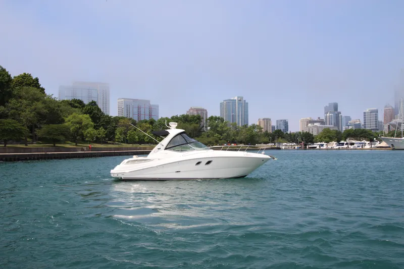 Slide: The Image of Sea Ray 330 Sundancer 2012 yacht cruising near city skyline and waterfront park. - 2