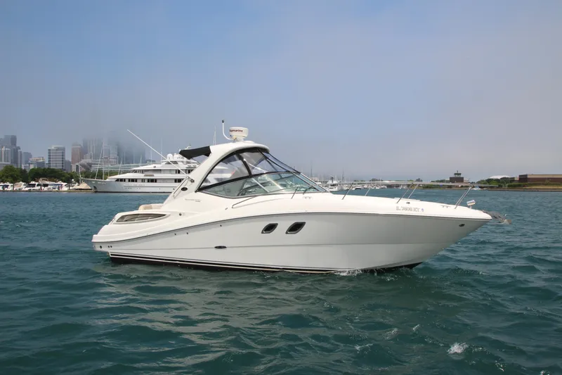 Slide: The Image of 2012 Sea Ray 330 Sundancer cruising on a calm waterway. - 3