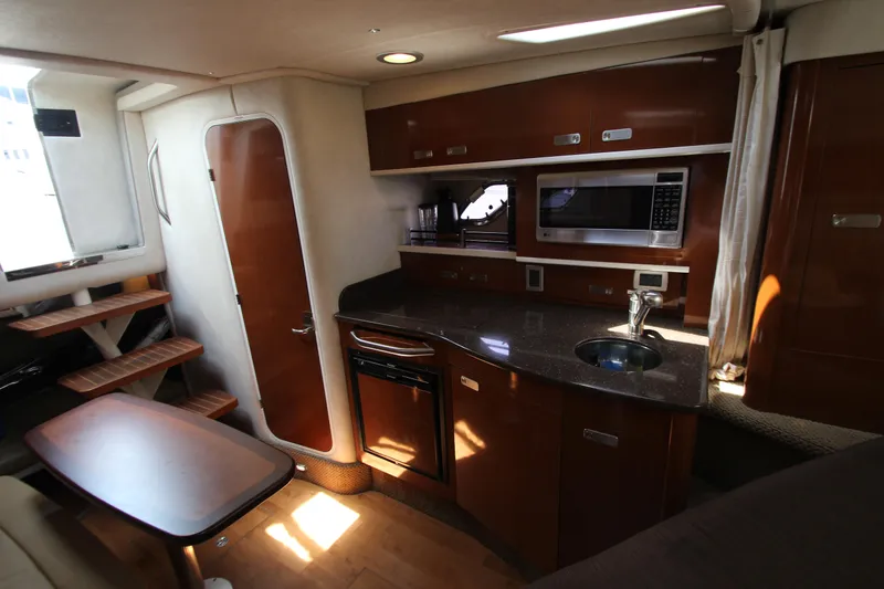 Slide: The Image of Interior of 2012 Sea Ray 330 Sundancer yacht with kitchen and dining area. - 34