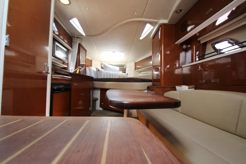 Slide: The Image of Interior of 2012 Sea Ray 330 Sundancer yacht with modern amenities and wooden finishes. - 40