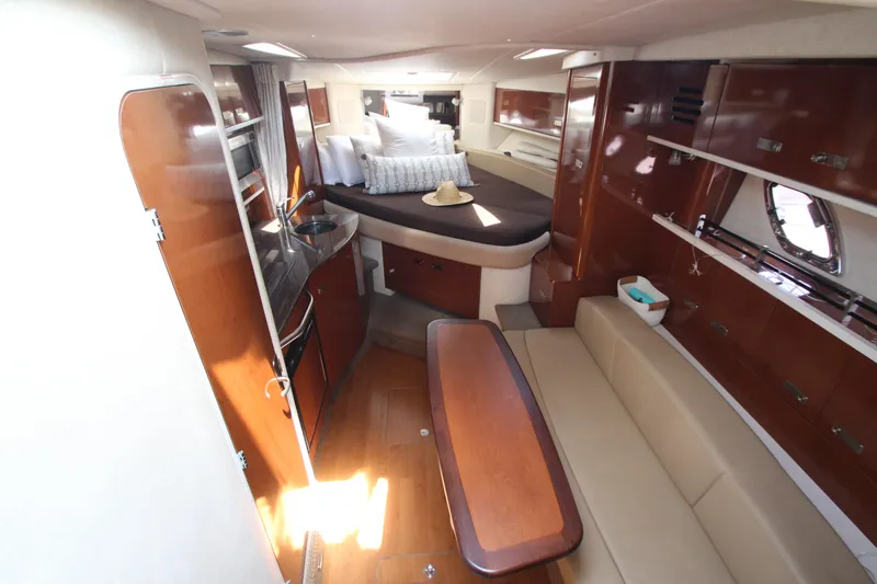 Slide: The Image of Interior of 2012 Sea Ray 330 Sundancer yacht with modern amenities and cozy seating. - 26